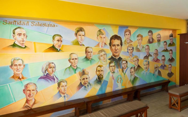 Mural de la santidad salesiana con los santos y beatos de la familia salesiana